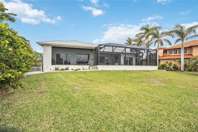 back of property with a yard and glass enclosure