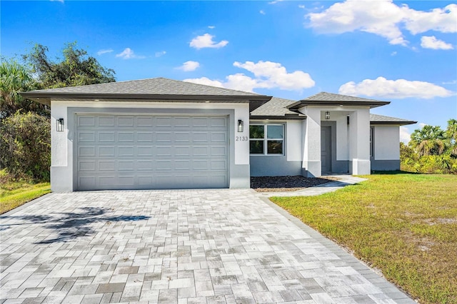 view of front of property with a front yard and a garage