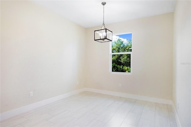 empty room featuring an inviting chandelier