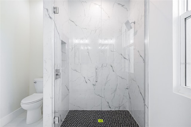 bathroom featuring toilet and a shower with door