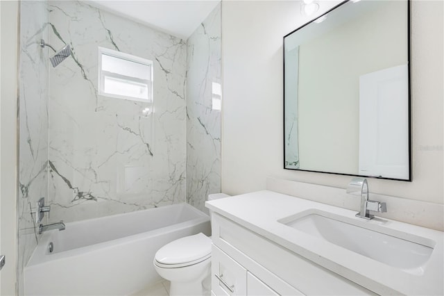 full bathroom featuring tiled shower / bath, vanity, and toilet