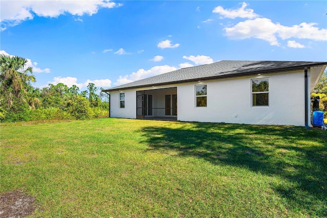 back of house with a yard