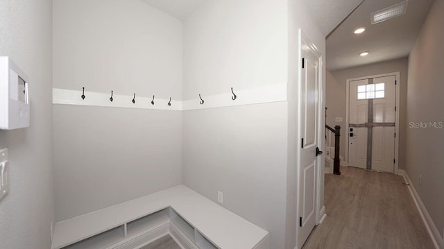 mudroom with wood-type flooring