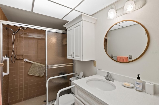 bathroom with vanity, a shower with shower door, and toilet