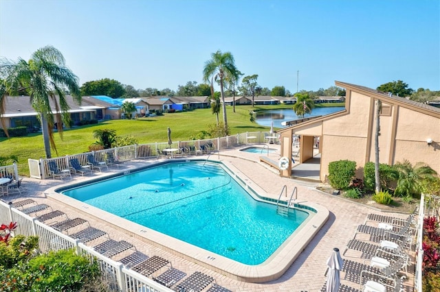 view of pool featuring a community hot tub, a patio area, and a water view