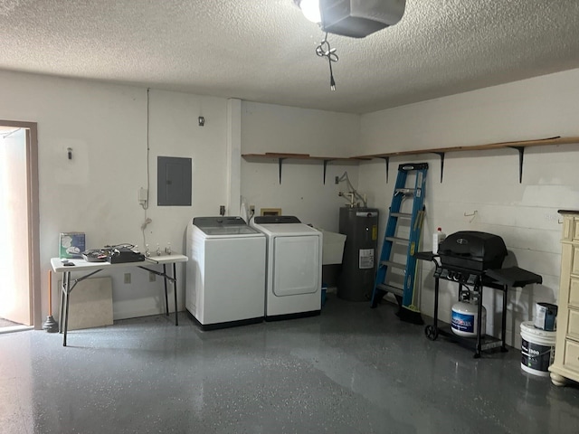 clothes washing area featuring electric water heater, washer and dryer, electric panel, and a textured ceiling