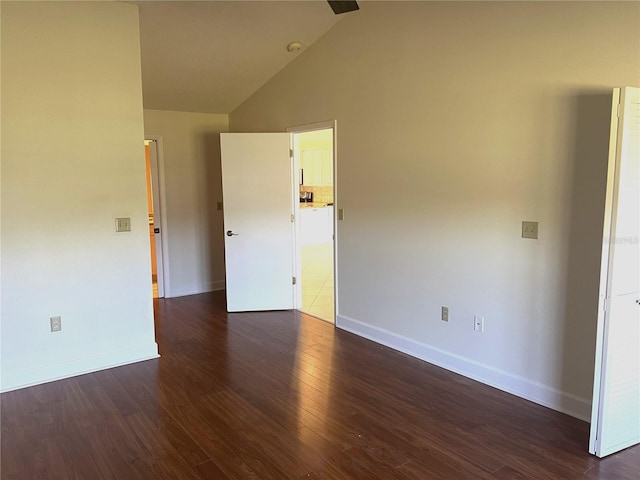 empty room featuring lofted ceiling and dark hardwood / wood-style floors