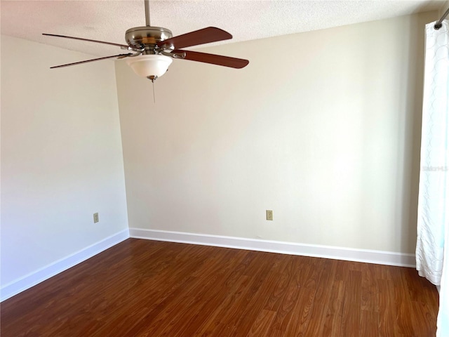 unfurnished room with dark wood-type flooring and a textured ceiling