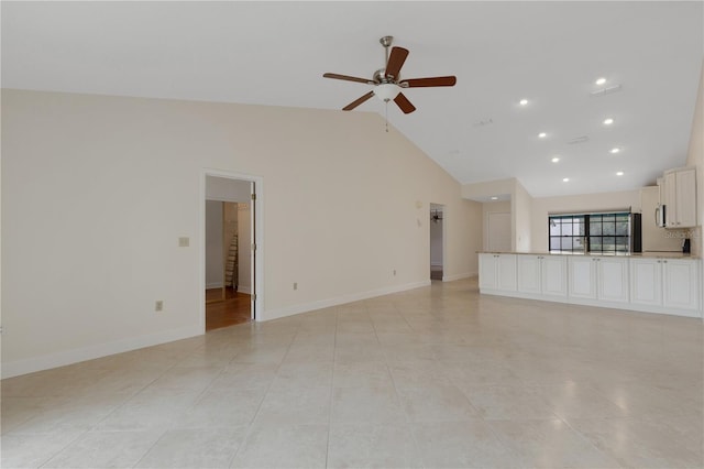 unfurnished living room featuring ceiling fan, high vaulted ceiling, and light tile patterned floors