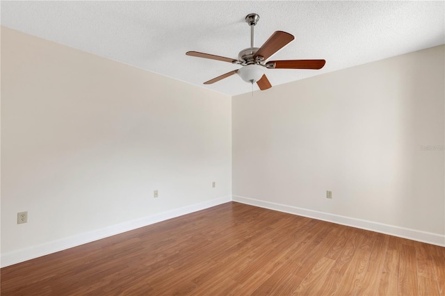 empty room with hardwood / wood-style floors, a textured ceiling, and ceiling fan