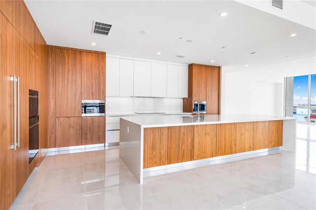 111 Golden Gate Pt Unit 701Ph, Sarasota, FL 34236 - kitchen with modern cabinets, visible vents, and oven
