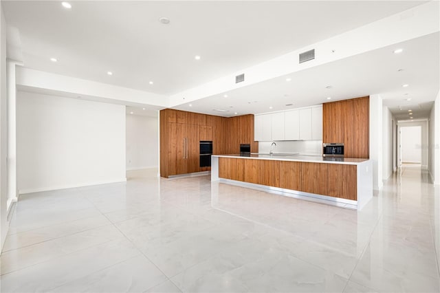 111 Golden Gate Pt Unit 701Ph, Sarasota, FL 34236 - kitchen featuring visible vents, modern cabinets, stainless steel microwave, brown cabinets, and recessed lighting