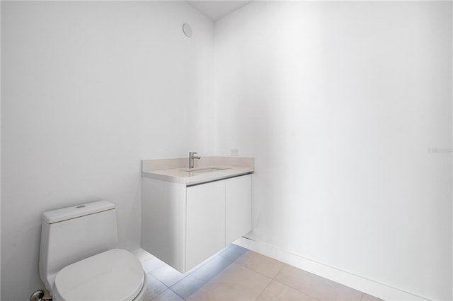 111 Golden Gate Pt Unit 701Ph, Sarasota, FL 34236 - half bathroom featuring tile patterned floors, toilet, baseboards, and vanity