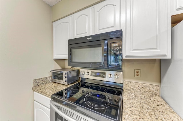 kitchen featuring white cabinets, light stone countertops, and stainless steel range with electric cooktop