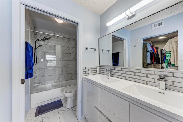 full bathroom featuring vanity, toilet, enclosed tub / shower combo, a textured ceiling, and tasteful backsplash