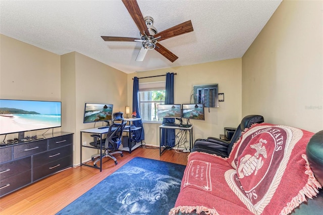 office space featuring ceiling fan, wood-type flooring, and a textured ceiling