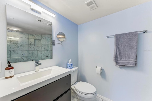 bathroom featuring vanity, a shower with shower door, and toilet