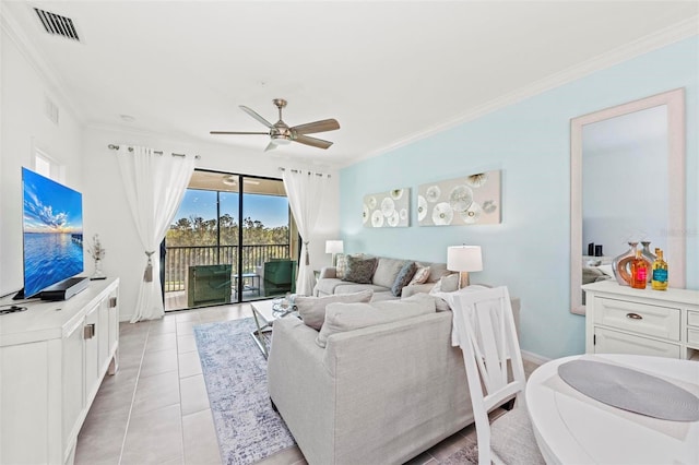 living room with light tile patterned flooring, ceiling fan, and crown molding