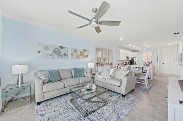 tiled living room featuring ceiling fan and crown molding