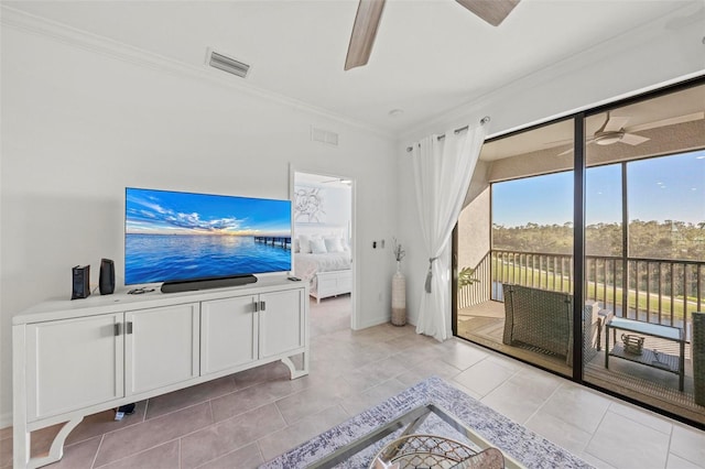 tiled living room with ceiling fan and crown molding