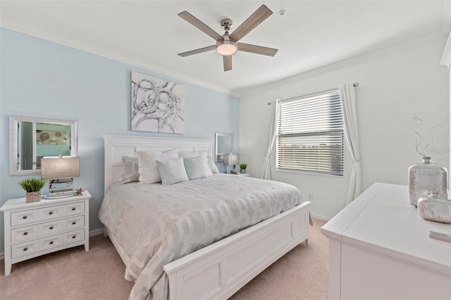 carpeted bedroom featuring ceiling fan and ornamental molding