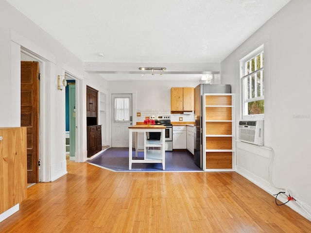 kitchen with light wood-type flooring, backsplash, stainless steel appliances, cooling unit, and white cabinets