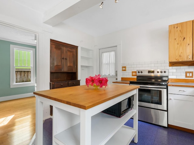 kitchen featuring butcher block countertops, white cabinetry, tasteful backsplash, and electric stove