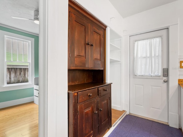 doorway to outside featuring ceiling fan and light hardwood / wood-style floors