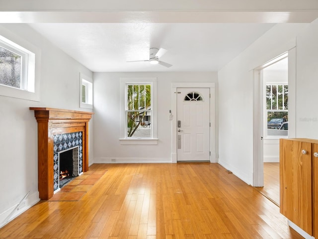 foyer featuring ceiling fan and light wood-type flooring