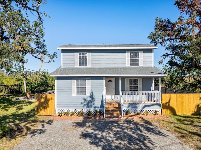 view of front of home with a porch and a front yard