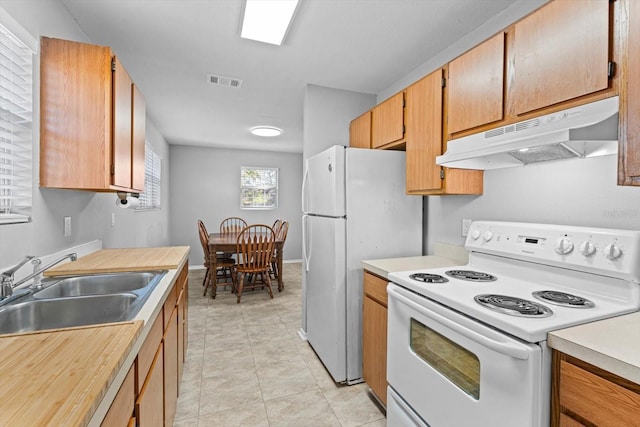 kitchen featuring white appliances and sink