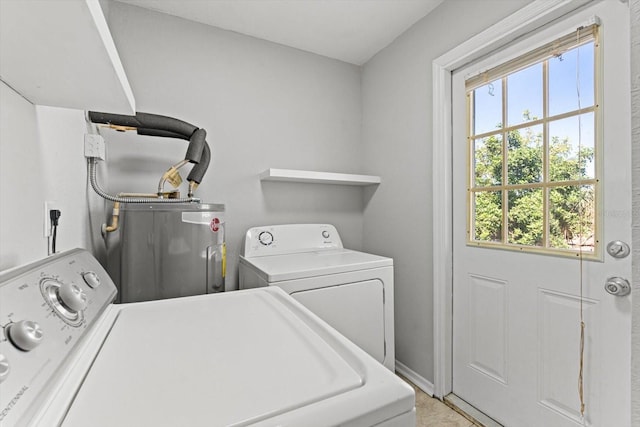 laundry room featuring electric water heater and independent washer and dryer