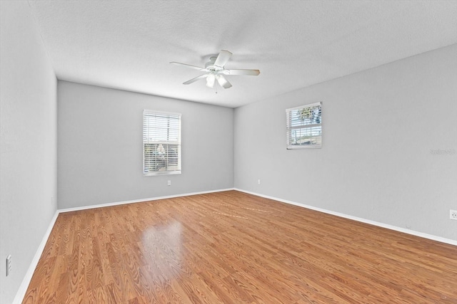 unfurnished room featuring a textured ceiling, ceiling fan, and hardwood / wood-style flooring