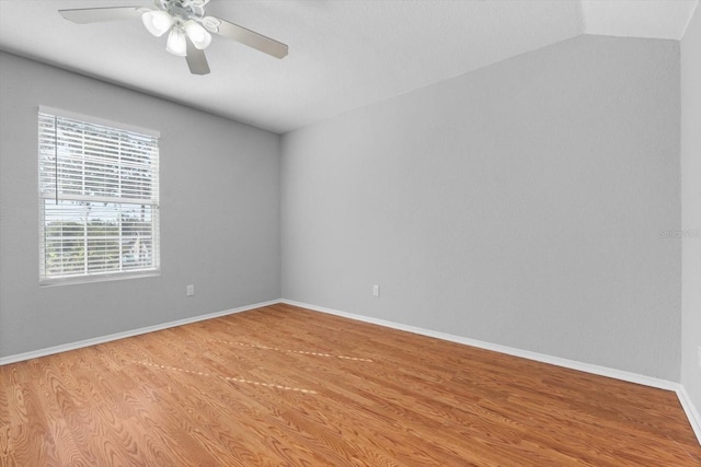 spare room with light hardwood / wood-style floors, ceiling fan, and vaulted ceiling