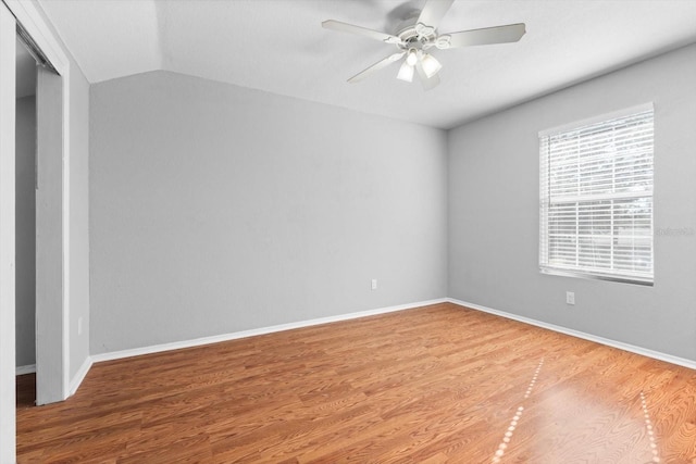 unfurnished room featuring lofted ceiling, hardwood / wood-style flooring, and ceiling fan