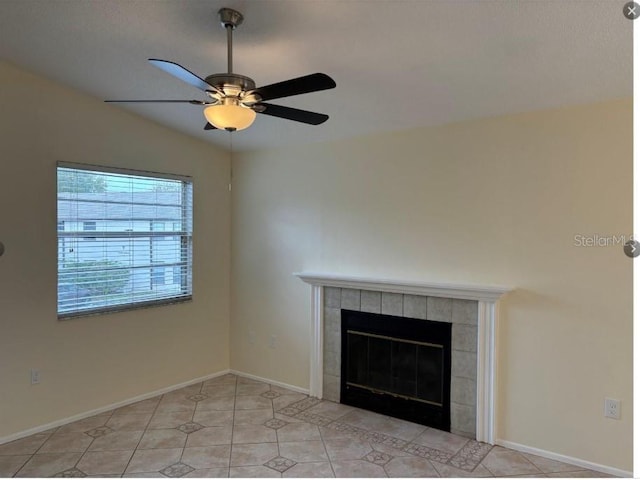 room details featuring ceiling fan and a tiled fireplace