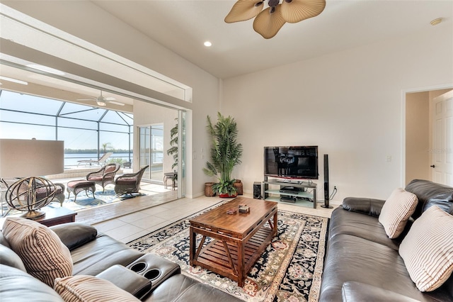 tiled living room featuring a water view