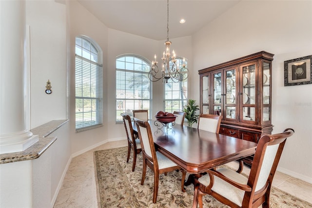 dining space featuring a chandelier and ornate columns