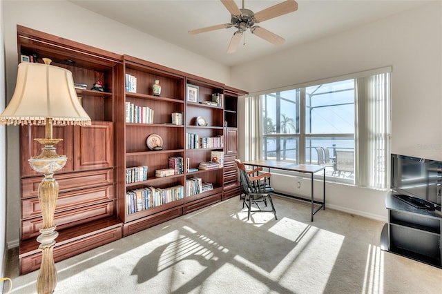 carpeted home office with ceiling fan