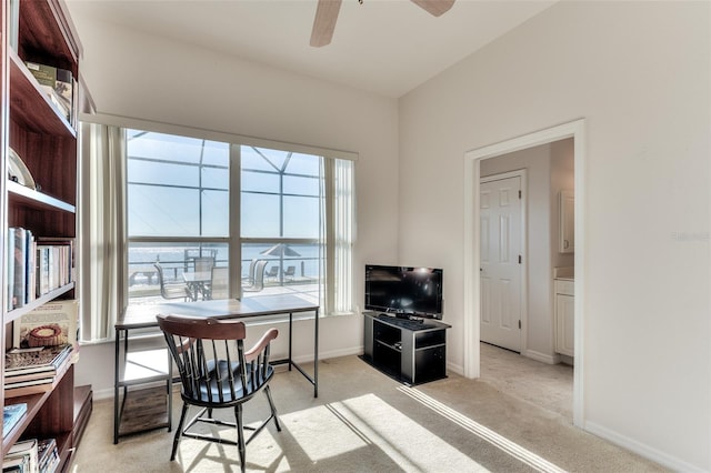 office space with ceiling fan and light colored carpet