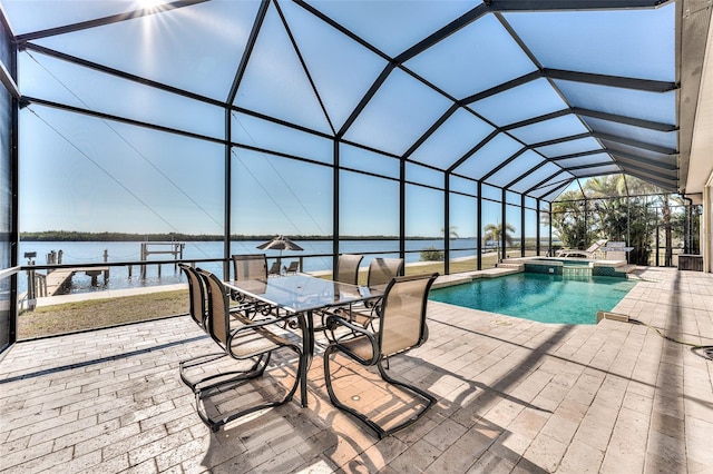 view of swimming pool featuring glass enclosure, a patio area, an in ground hot tub, and a water view