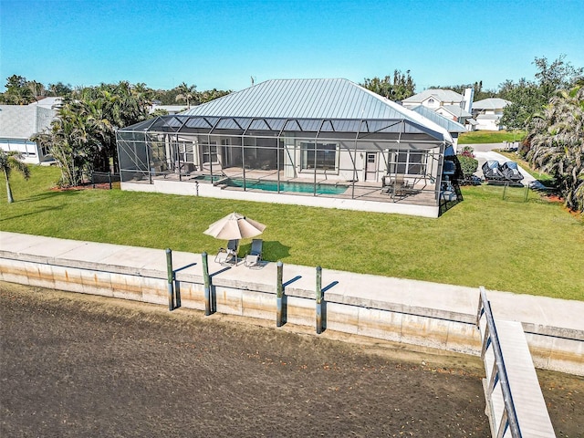 view of swimming pool featuring glass enclosure, a patio area, and a yard