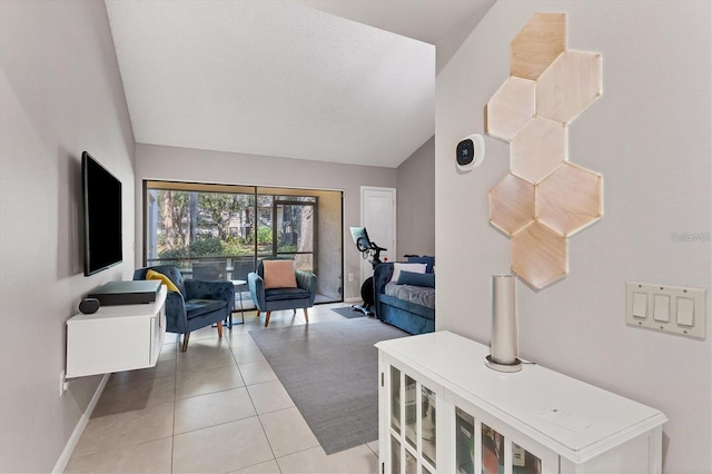 living area with baseboards, vaulted ceiling, and light tile patterned flooring