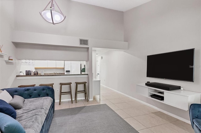 tiled living room featuring high vaulted ceiling