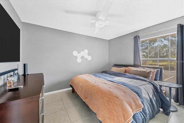 bedroom featuring light tile patterned floors, a textured ceiling, and ceiling fan