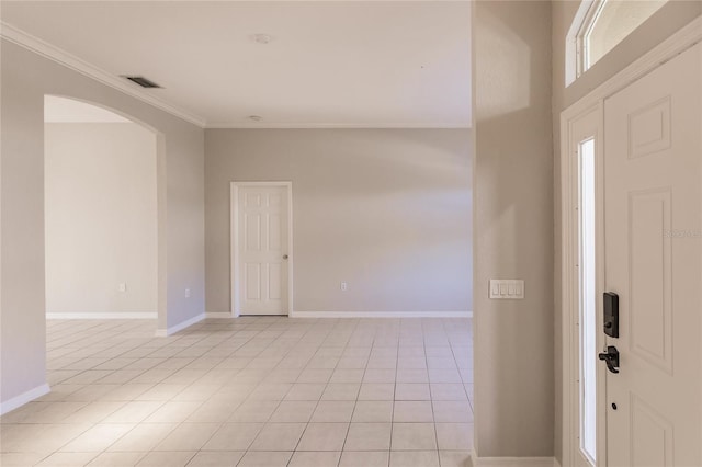 entrance foyer featuring crown molding and light tile patterned flooring