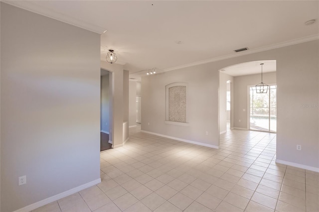 tiled empty room featuring crown molding