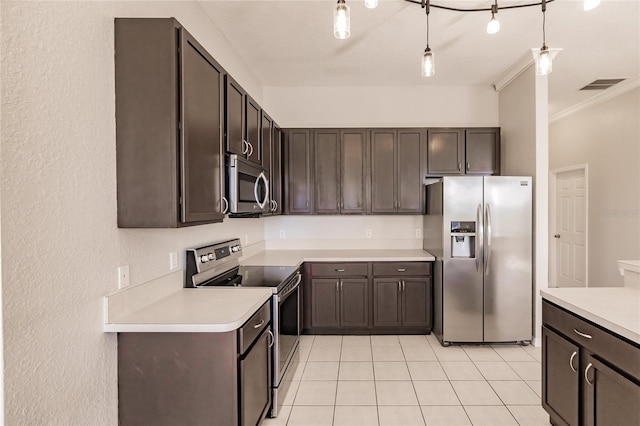 kitchen featuring dark brown cabinetry, ornamental molding, hanging light fixtures, and appliances with stainless steel finishes