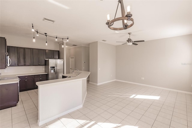 kitchen featuring sink, stainless steel appliances, an island with sink, light tile patterned flooring, and ceiling fan with notable chandelier