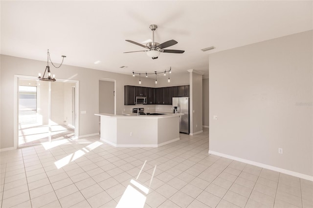 kitchen with dark brown cabinets, light tile patterned floors, ceiling fan with notable chandelier, and appliances with stainless steel finishes